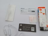two ear buds and a pair of earplugs sitting on a table