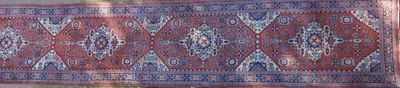 an image of a red and blue oriental rug on display