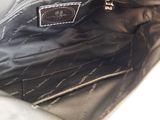 a black purse that is open on a white surface