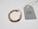 a close up of a small gold hoop earring with a price tag