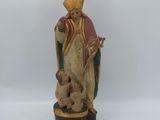 an old statue of a man with a dog on a pedestal