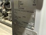 a metal sign on the side of a machine