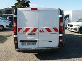 a white van parked in a parking lot with other cars