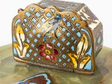 a small decorative box sitting on top of a table