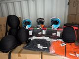 many boxes and helmets on top of each other in a container