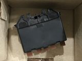 a box that has a piece of black plastic in it