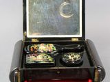 a small black box with two bowls of food inside of it
