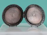 pair of antique silver plated cufflinks on a white marble base