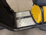 a motor scooter that is parked in a garage