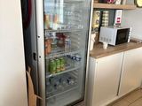a refrigerator that is open in a kitchen with a sign on the door