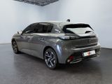 the rear end of a silver car in a showroom