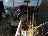 a tank with a hose attached to it in the grass