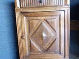 a small wooden cabinet with a diamond design on it