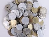 a pile of silver and gold coins on a white surface