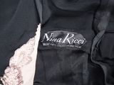 a close up of a black jacket with a white label on it
