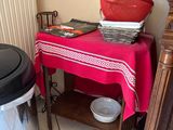 a table with a red table cloth and a red pot on it