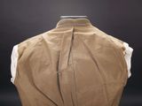 the back of a tan jacket with a white shirt on a mannequin mannequin mannequin mannequin mannequin mannequin manne