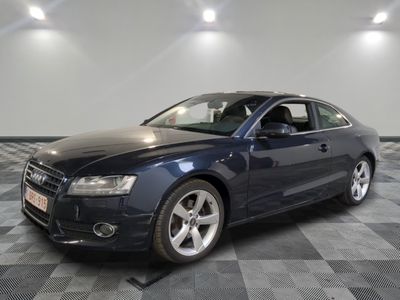 a picture of a dark blue audi parked in a garage
