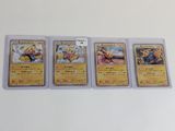 un lot de quatre cartes Pokémon posées sur une table