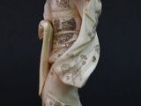 statue of a woman in a kimono dress holding a fan