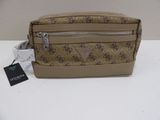 a brown and tan purse with a small tag on it