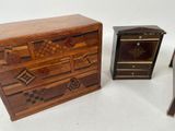 three pieces of furniture including a chest of drawers and a side table