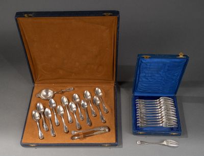 un service d'argenterie dans un coffret bleu et un ensemble de cuillères en argent dans un coffret bleu