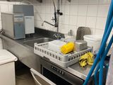 a kitchen with a sink, dishwasher, and a washing machine