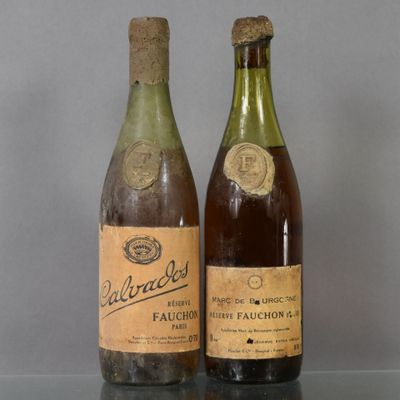 two bottles of wine sitting on a table next to each other