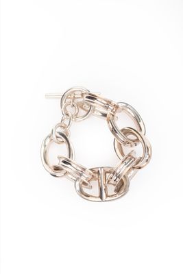 a close up of a chain bracelet on a white background