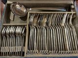 a lot of silverware in a box on a table