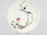 an image of a plate with a bird and flowers painted on it