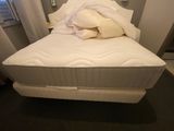 a white bed with a pillow on top of it