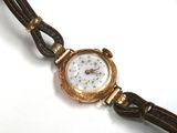 a close up of a wrist watch on a white surface