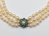 a three strand pearl necklace with turquoise and white pearls