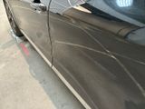 a black car parked on the side of the street