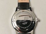 a close up of a watch on a white surface