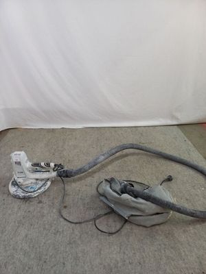 un aspirateur posé sur le sol à côté d'un mur