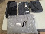 a lot of t - shirts that are on a table