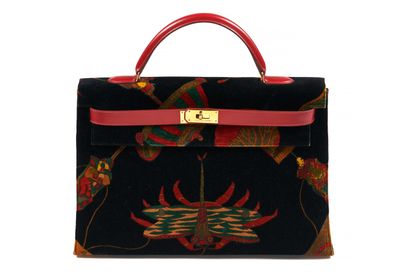 a black and red handbag with a red handle