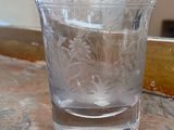a glass of water sitting on a counter next to a mirror