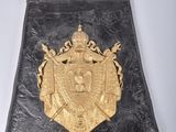 a black purse with a gold emblem on it