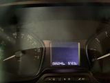 a close up of a car dashboard with a digital clock