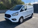 a white ford transit van parked in a parking lot