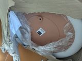 a plastic object in a cardboard box that is wrapped in plastic