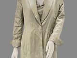 a mannequin dressed in a gold jacket and black pants