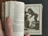 someone is holding an open book with a picture of a monkey on it