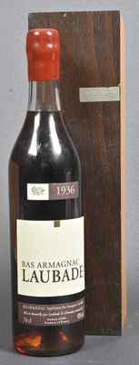 a bottle of liquor sitting next to a wooden box