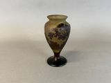 a vase with a floral design on it on a table