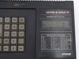a computer keyboard and a calculator sitting on a table